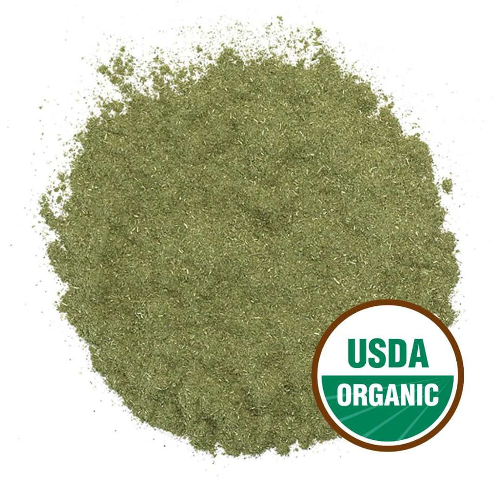 Pile of green andrographis powder with USDA Organic label on a white background