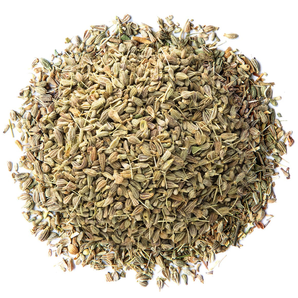 Pile of dried anise seeds on a white background.