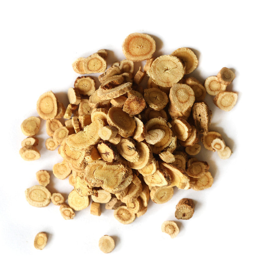 A pile of cut pieces of Astragalus root is on a white background.
