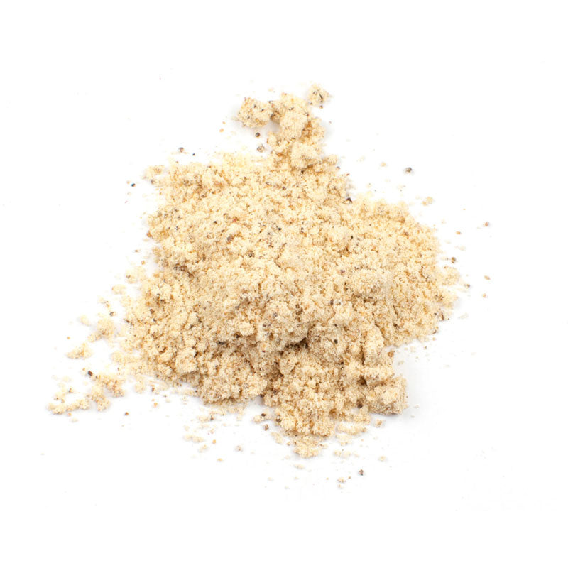 Pile of asafoetida powder on a white background.